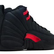 Black sneaker with red accents on a white background