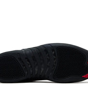 Black sneaker with red accents on a white background