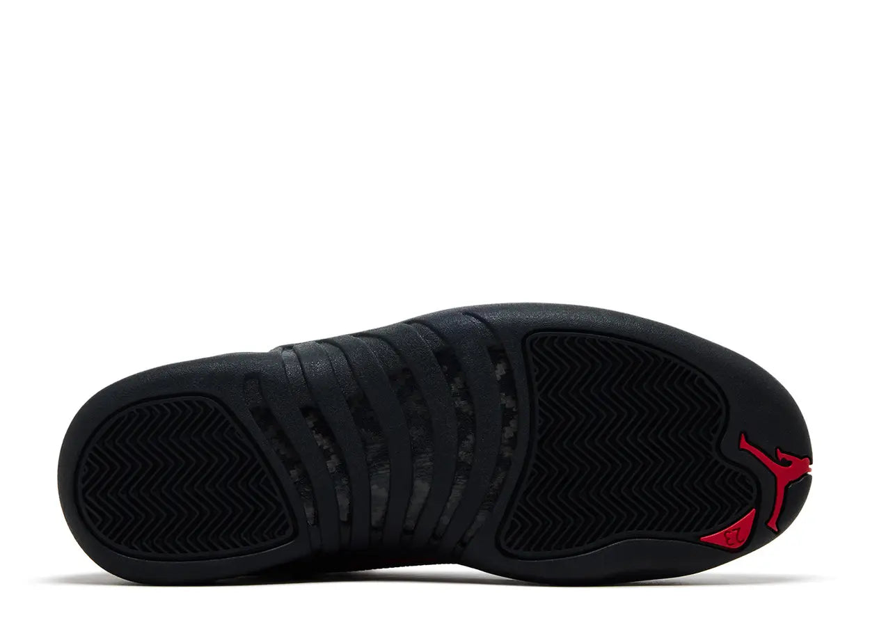 Black sneaker with red accents on a white background