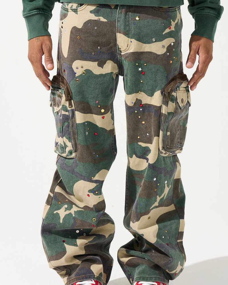 Camouflage pants worn by a person with red shoes on a white background