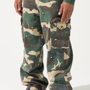 Person wearing camouflage pants with red shoes on a white background
