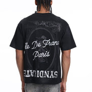 Person wearing a black t-shirt with white text and graphics on the back, standing against a white background.