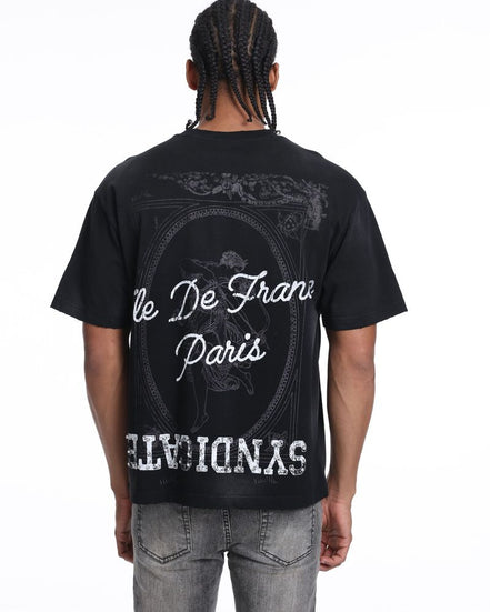 Person wearing a black t-shirt with white text and graphics on the back, standing against a white background.