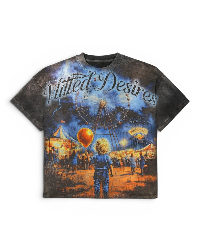 A short-sleeve crewneck t-shirt featuring a detailed graphic print of the text 'Vtilted Desires', showing a carnival scene with a Ferris wheel, hot air balloon, and a child in the foreground, set against a plain white background.