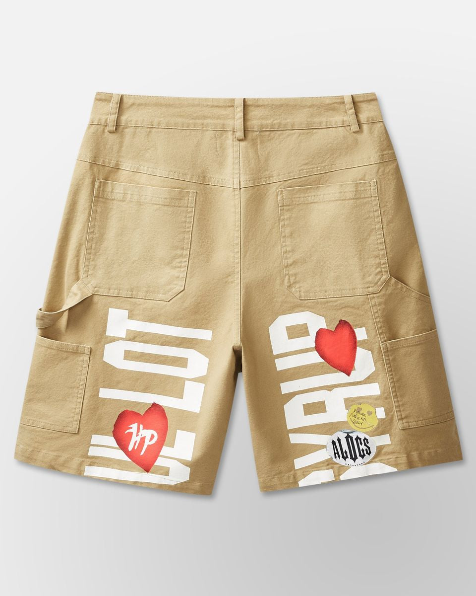 Beige shorts with graphic designs on a light gray background