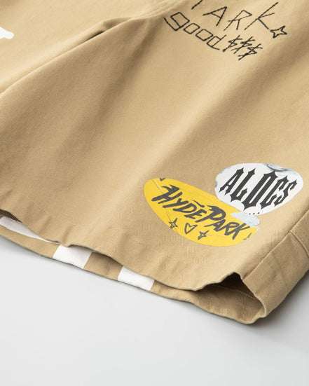 Beige shorts with visible branding on a light gray background