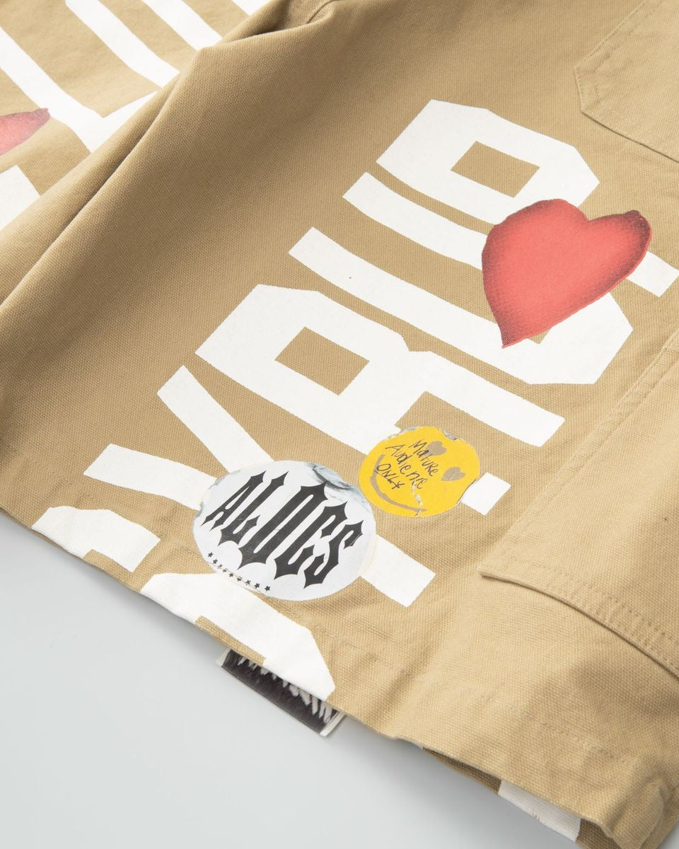 Beige jacket with white text and red heart design on a light gray background