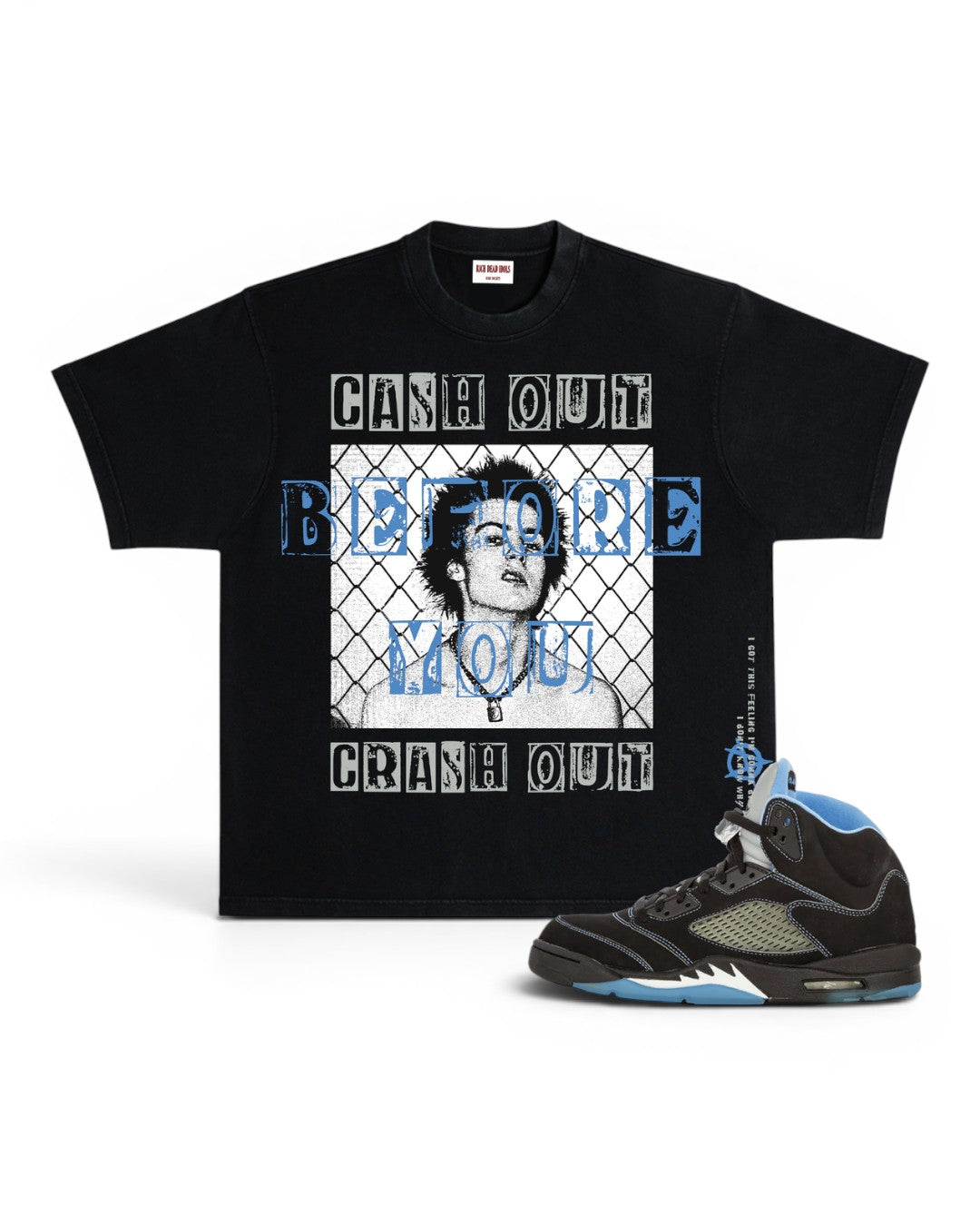 A black graphic t-shirt featuring a portrait of Mary Jane and the text 'CASH OUT BEFORE YOU CRASH OUT' in white and blue, shown next to a black and blue high-top sneaker on a white background.
