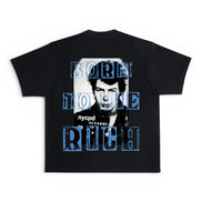 A black short-sleeve t-shirt with a graphic print on the back featuring a black-and-white portrait of One Direction's Nick Carter and the text 'BORN TO BE RICH' in distressed blue letters, with 'nycpd' printed below.