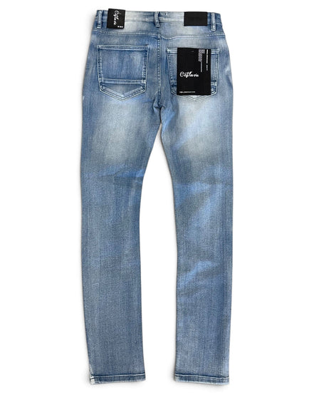 Light blue denim jeans shown from the back, featuring a faded wash, two rear pockets, and black brand labels attached to the waistband and back pockets.