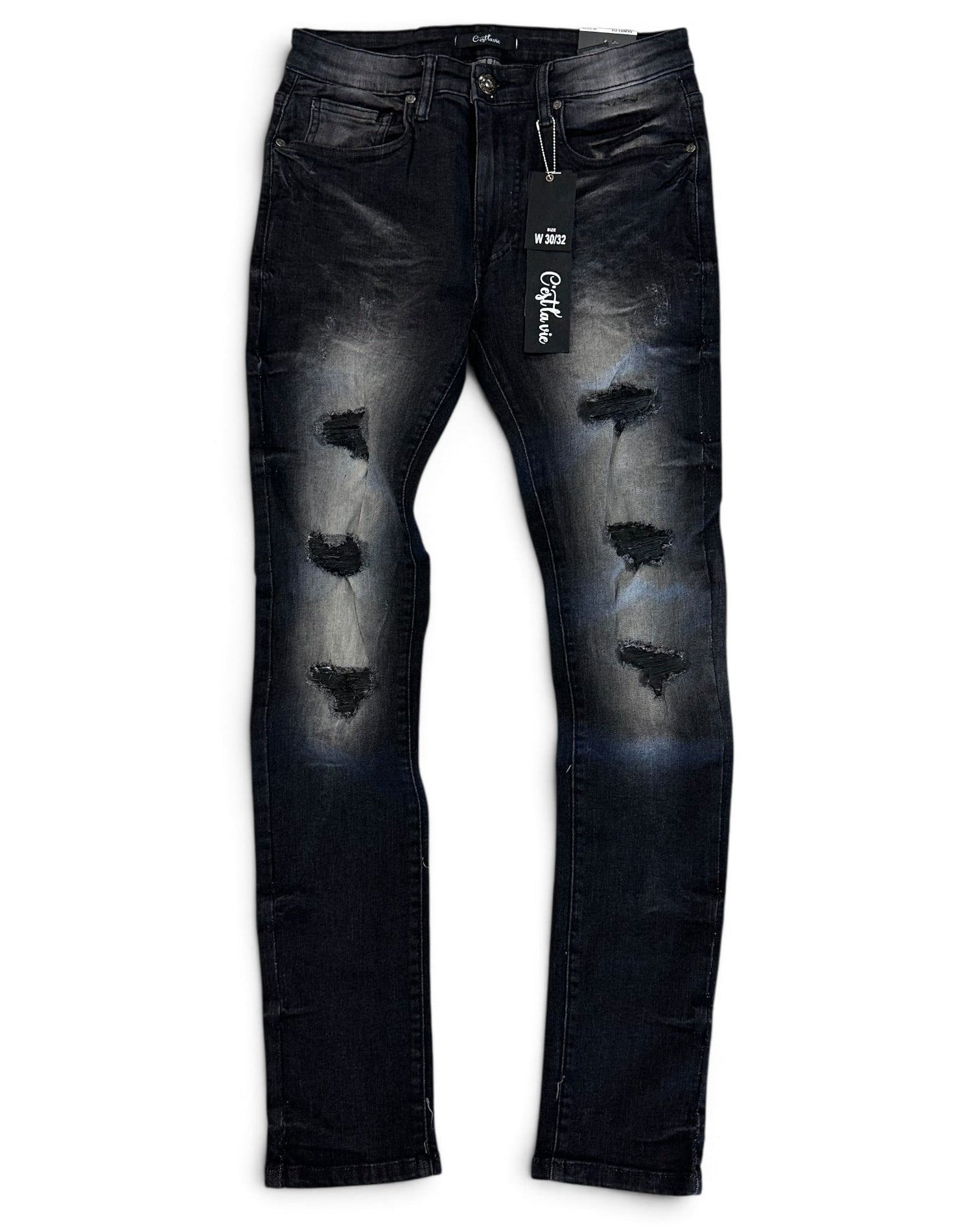Distressed black denim jeans with faded gray wash details and ripped knee patches, shown flat against a white background with a hangtag attached.