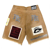 Beige shorts with patches and text on a white background