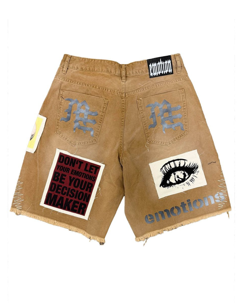 Beige shorts with patches and text on a white background