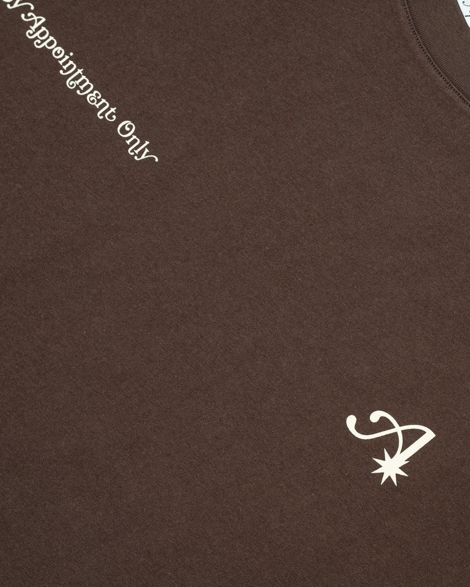 Brown t-shirt with white text and logo on a brown background