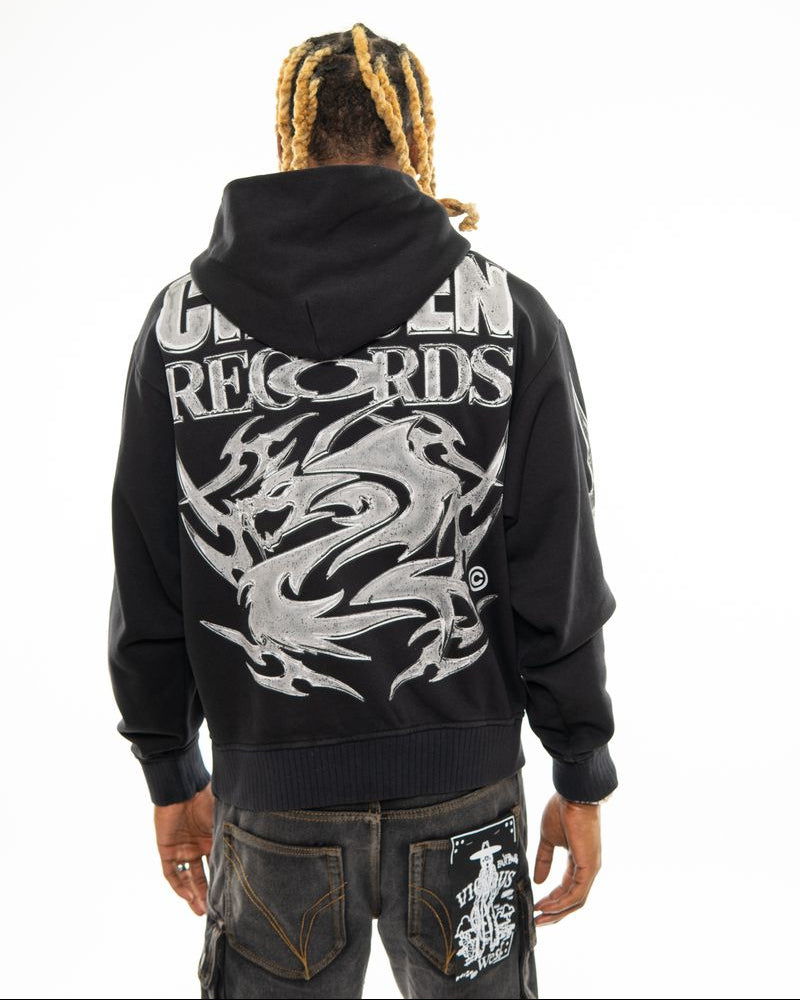 Person wearing a black hoodie with 'G-Unit Records' branding and a white dragon design on the back.