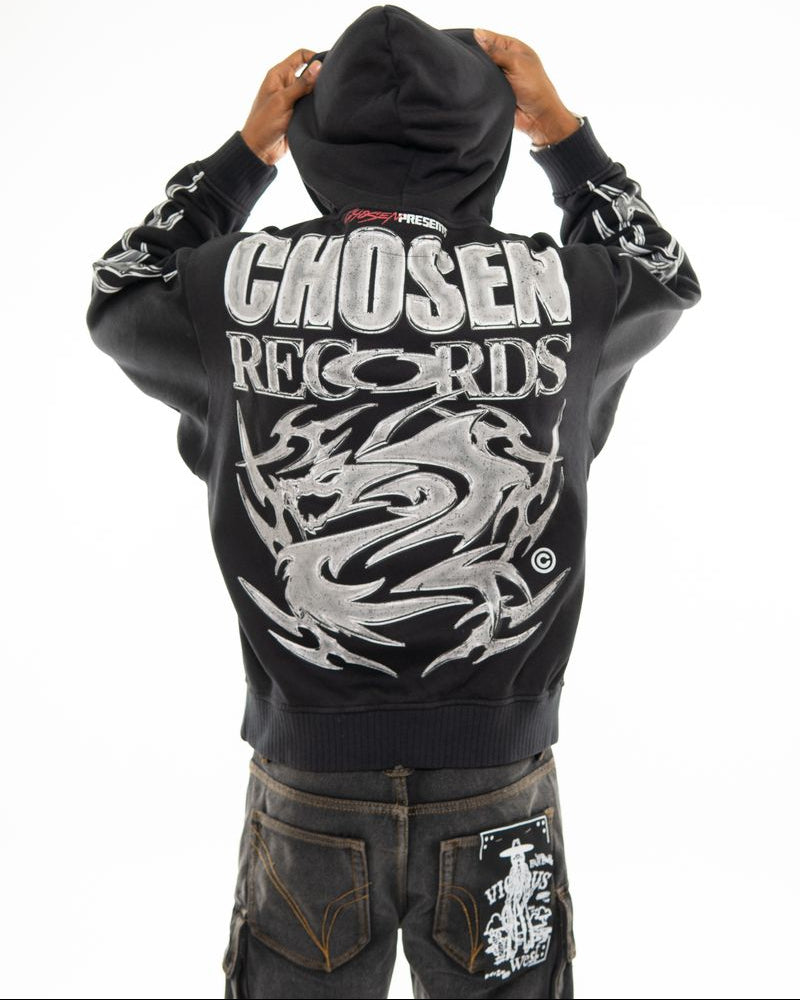 Black hoodie with 'Chosen Records' text and dragon design on the back, worn by a person.