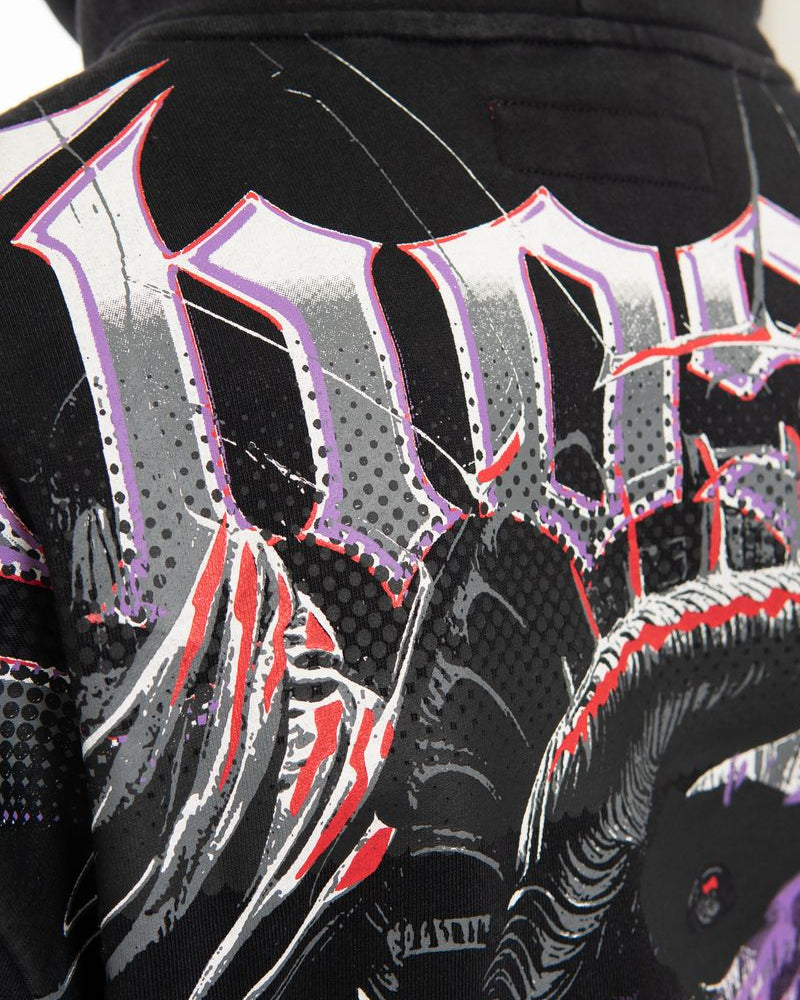 Close-up of a black jacket with colorful graphic designs and text.