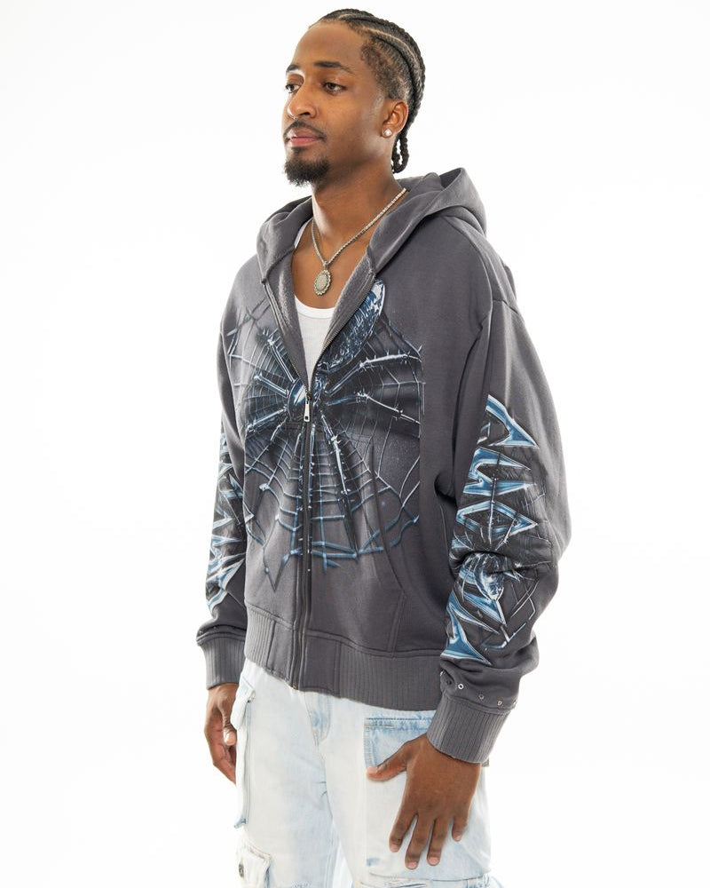 Man wearing a gray hoodie with blue designs on a white background