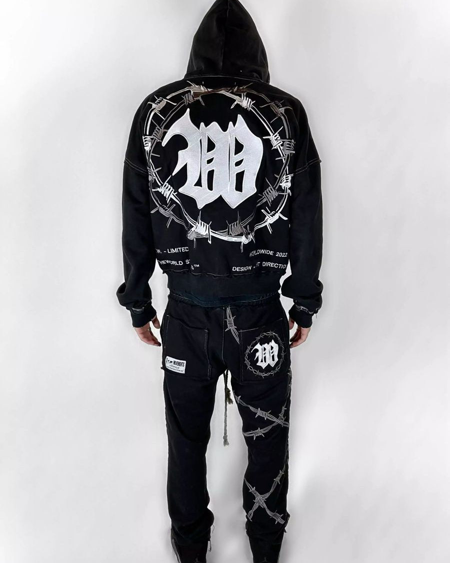 Black hoodie and pants set with barbed wire design on a white background