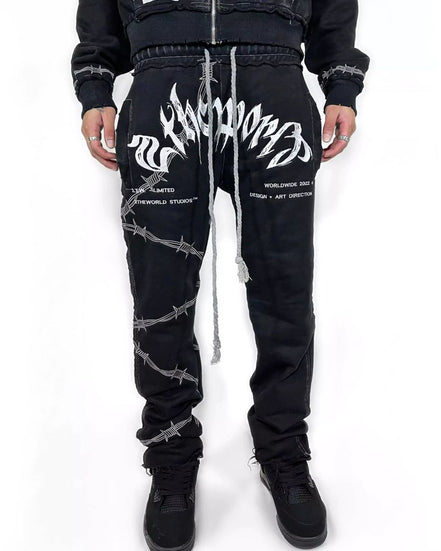 Black pants with white designs worn by a person on a white background