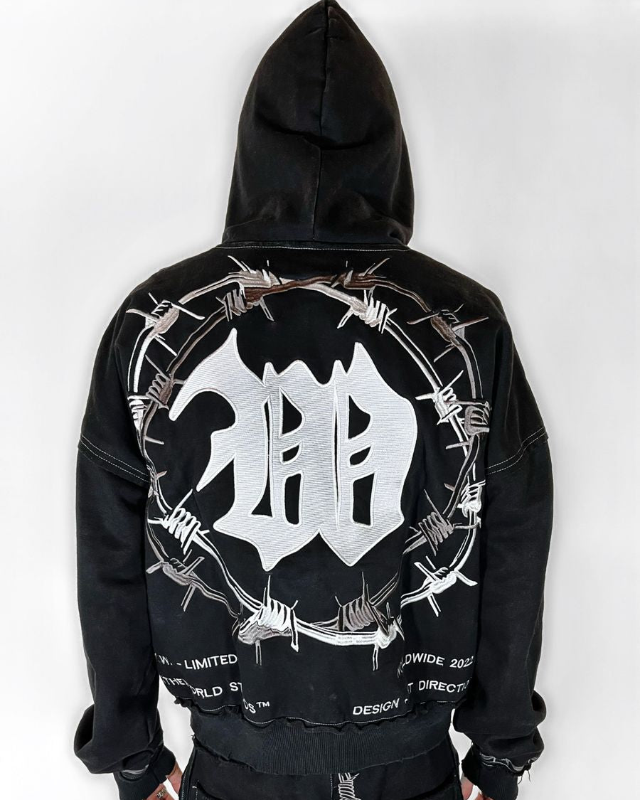 Black hoodie with a white logo and barbed wire design on the back against a white background