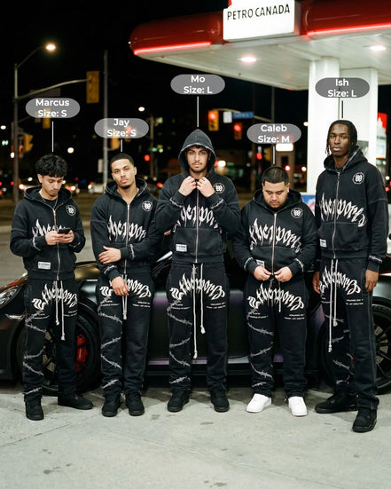 Five men wearing matching black outfits with white text standing in front of a Petro Canada gas station at night.