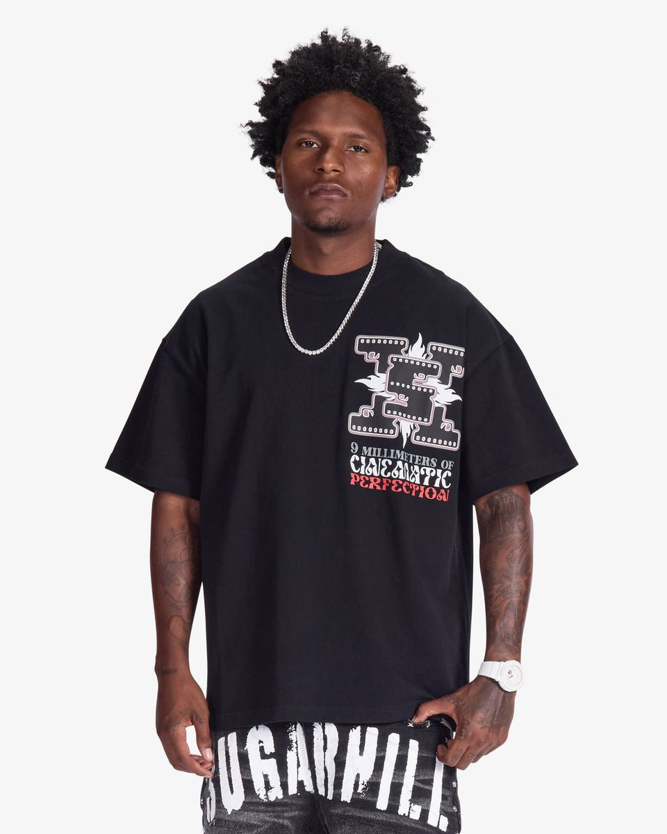 Man wearing a black t-shirt with graphic design and text on a white background