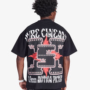 Person wearing a black t-shirt with white and red graphics on the back, on a white background