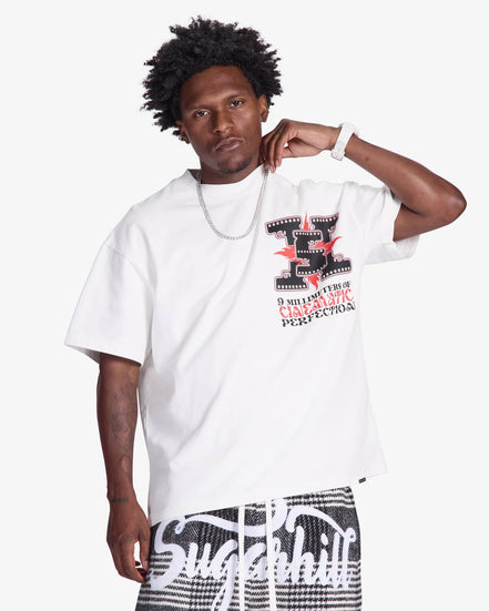 Man wearing a white t-shirt with graphic design on a plain background