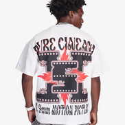 Person wearing a white t-shirt with graphic design on the back, standing against a plain background