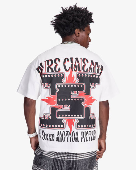 Person wearing a white t-shirt with graphic design on the back, standing against a plain background