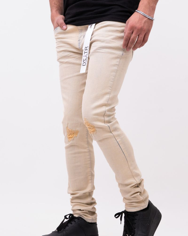 Beige pants with black shoes on a white background