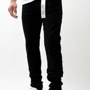 Person wearing black pants with a visible brand logo on a white background
