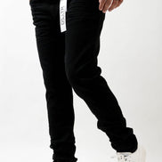 Person wearing black pants with a white brand logo on a white background