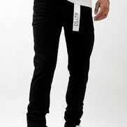 Person wearing black jogger pants with a visible brand logo on a white background