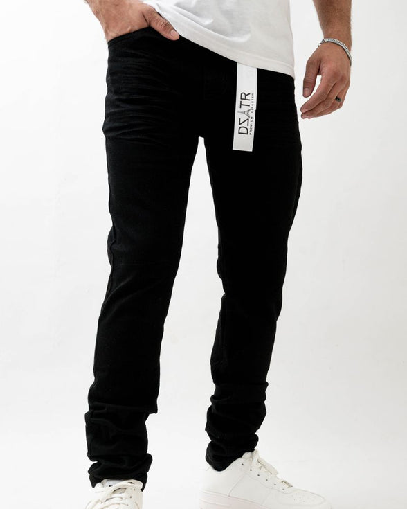 Person wearing black jogger pants with a visible brand logo on a white background