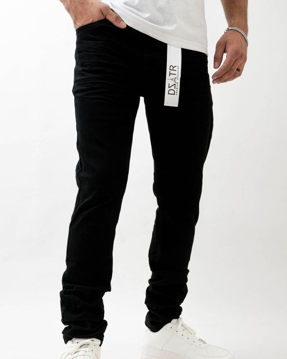 Person wearing black jogger pants with a visible brand logo on a white background