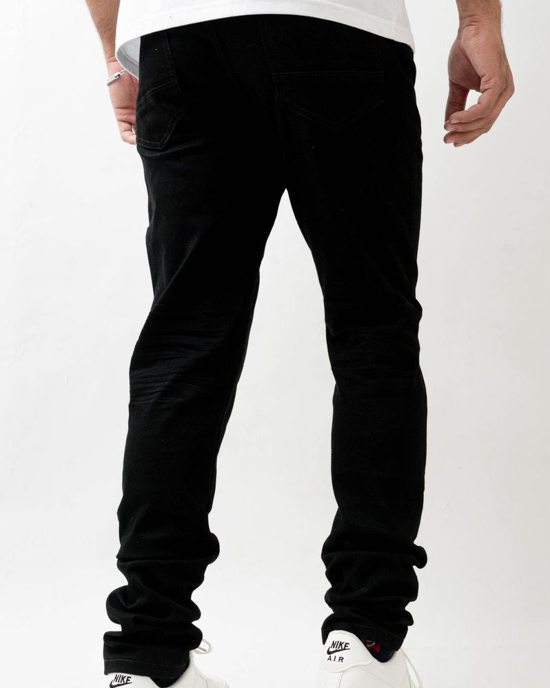 Person wearing black pants and white sneakers on a white background