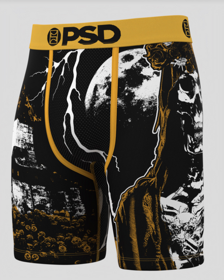 Black and gold graphic shorts with a skull design on a white background