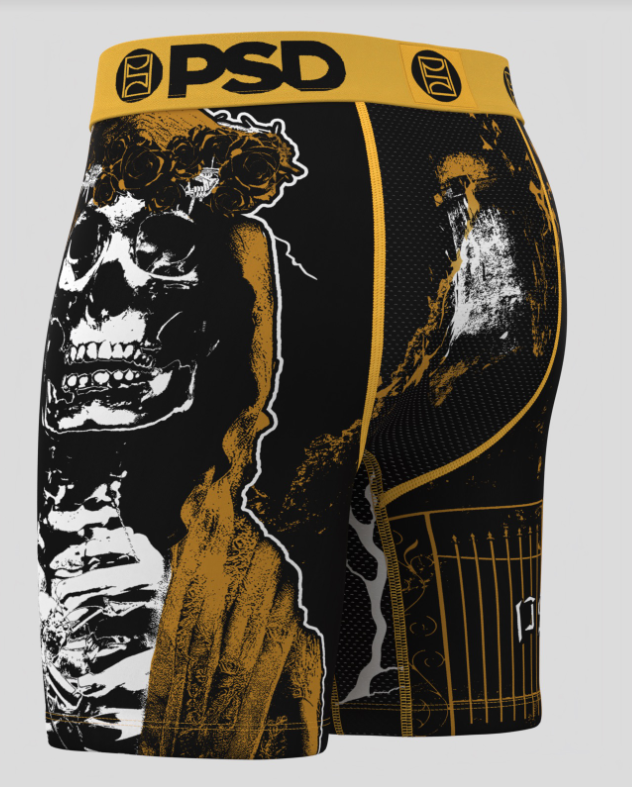 Skateboard shorts with a skeleton design and 'PSD' branding on a gray background