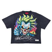 A dark charcoal gray graphic t-shirt featuring a detailed illustration of the Joker pointing a gun forward, with 'WRATHBOY' written in white script below, set against a plain white background.