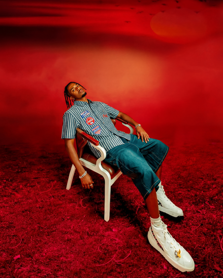 Person sitting on a chair against a red background