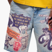 Denim shorts with artistic designs and text, worn with a yellow shirt.