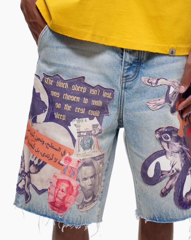 Denim shorts with artistic designs and text, worn with a yellow shirt.