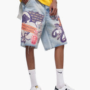 Person wearing a yellow shirt, colorful denim shorts, and white sneakers on a white background