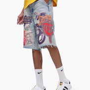 Person wearing a colorful graphic denim skirt with white sneakers on a white background