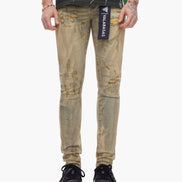 Distressed beige jeans with a brand label on a white background