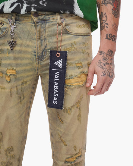 Distressed jeans with a visible brand tag on a white background