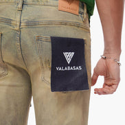 Close-up of a person wearing jeans with a Valabasas label on the back pocket.