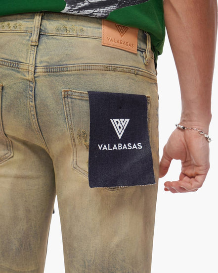 Close-up of a person wearing jeans with a Valabasas label on the back pocket.